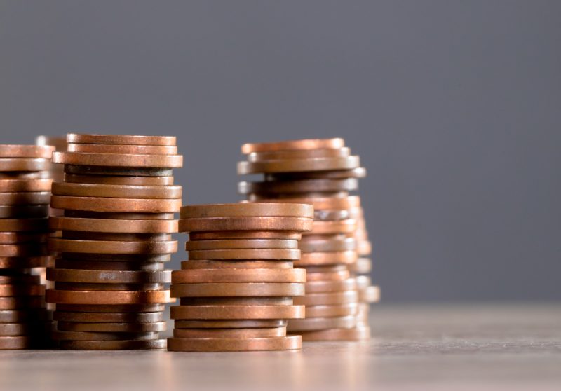 close-up-of-stack-of-coins-on-wooden-table-against-2021-09-02-21-23-48-utc.jpg