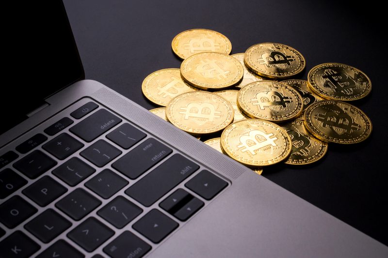 computer-and-golden-coins-with-bitcoin-symbol-on-a-2022-12-16-03-15-24-utc.jpg