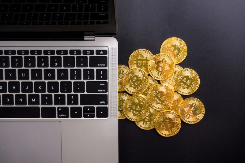 computer-and-golden-coins-with-bitcoin-symbol-on-a-2023-11-27-05-28-14-ut.jpeg