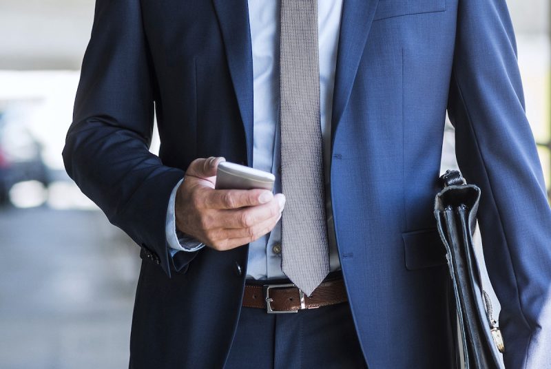 mature-businessman-on-park-deck-using-mobile-phone-2023-11-27-05-20-39-utc.jpg